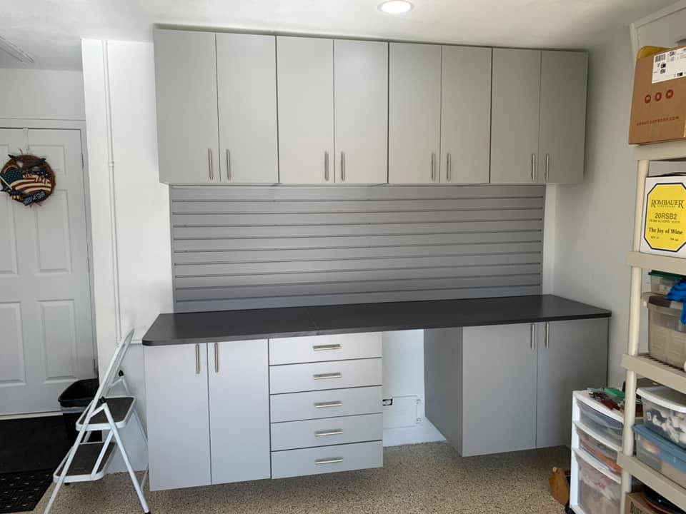 Garage cabinets with slatwall system on the back splash clear